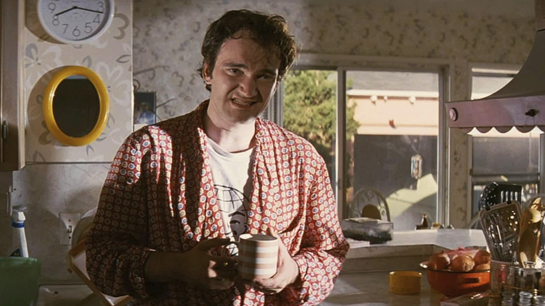 Quentin Tarantino grimaces as Jimmy wearing a bathrobe in Pulp Fiction