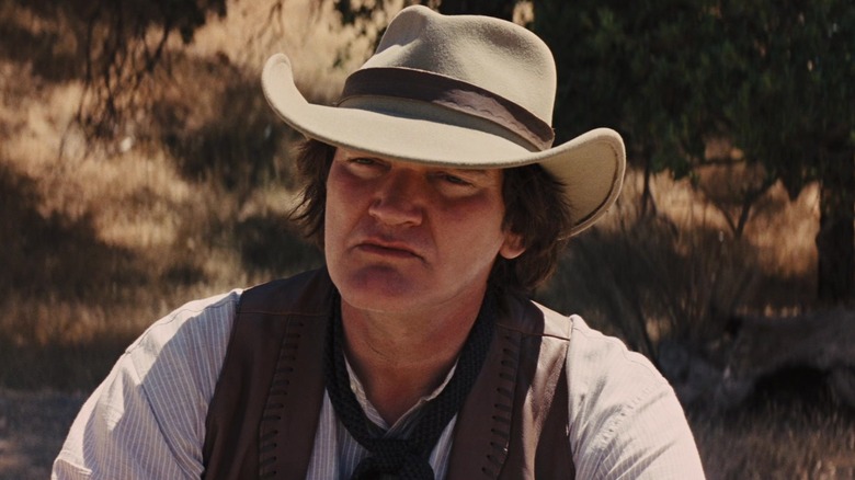 Quentin Tarantino as Robert sitting down and talking to Django in Django Unchained