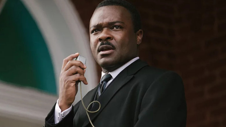 David Oyelowo as Martin Luther King Jr. in suit speaking into microphone in Selma