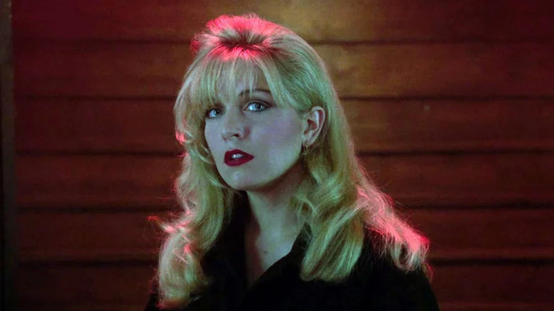 Sheryl Lee with curled hair and lipstick lit with red light and looking toward the camera in Twin Peaks: Fire Walk With Me