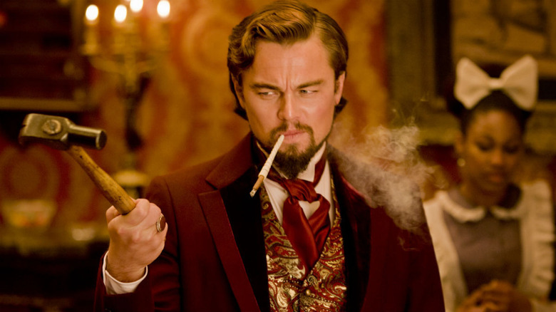 leonardo dicaprio holding a hammer and smoking in django unchained