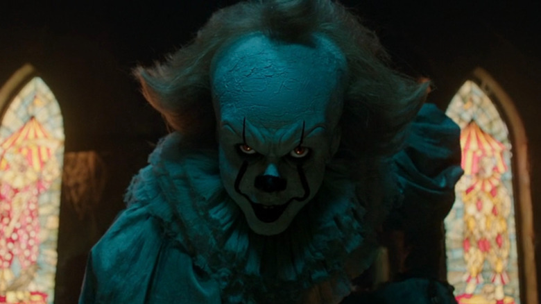 Pennywise the dancing clown smiles at Richie in It: Chapter Two