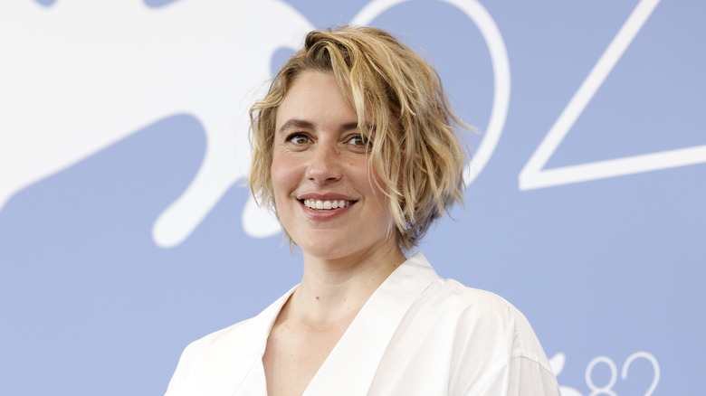 Greta Gerwig in a white top smiling