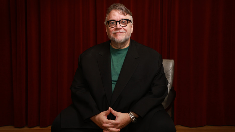 Guillermo del Toro sitting in chair