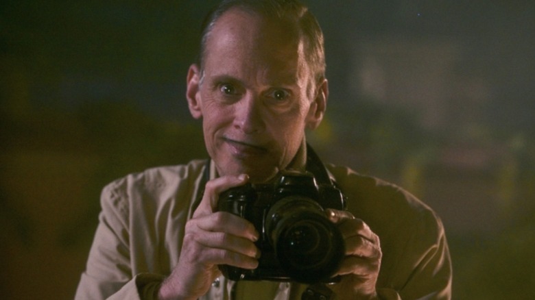 Pete Peters smirking with a camera in Seed of Chucky