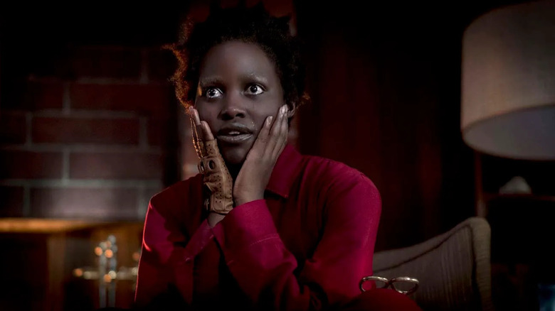 Red with her hands on her face in Us
