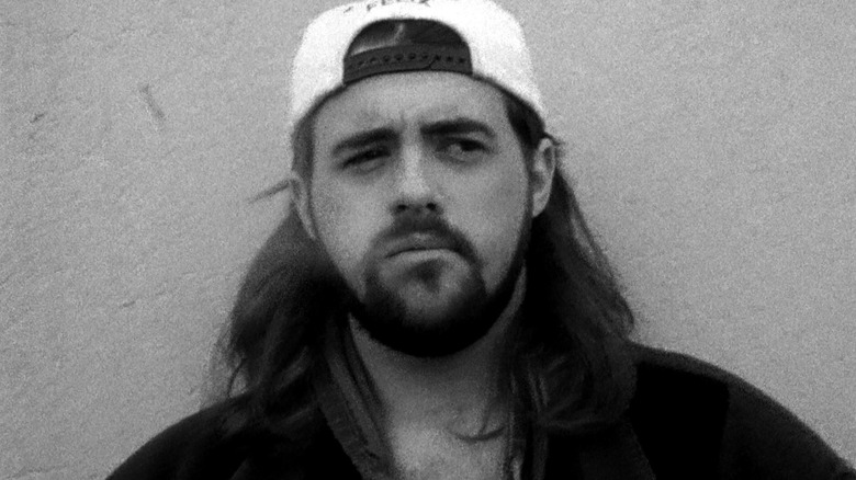 Kevin Smith as Silent Bob outside of the Quick Stop in Clerks