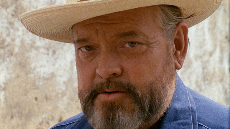 A bearded Orson Welles tells a tale in the documentary F for Fake
