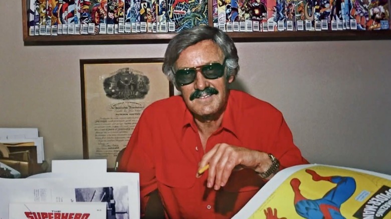 Stan Lee sitting at his desk in the 2023 Stan Lee documentary
