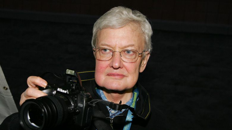 Roger Ebert holding a camera