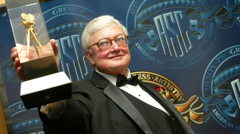 Roger Ebert holding an award