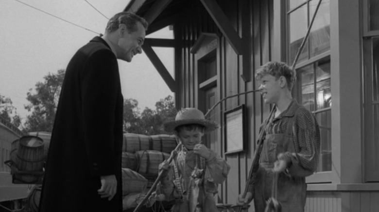 James Dali in the role of Williams Garta talks to two young boys after they got out of a train in the Twilight Zone a in Willoughby