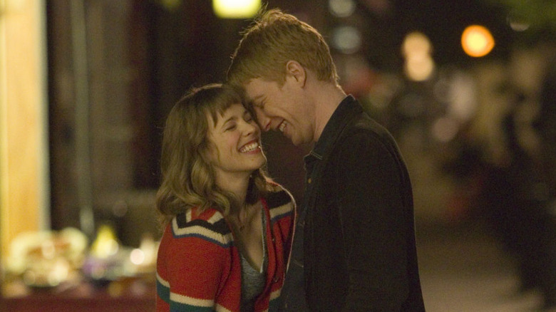 Rachel McAdams and Domhnall Gleeson smiling together in About Time