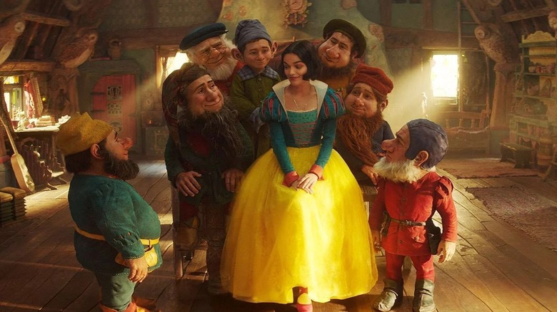 Snow White surrounded by the seven dwarfs in Snow White
