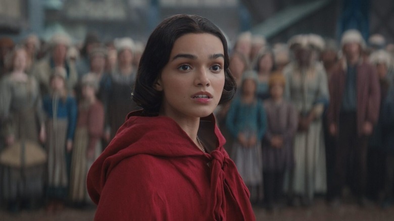 Rachel Zegler as Snow White wearing a red cloak in Snow White (2025)