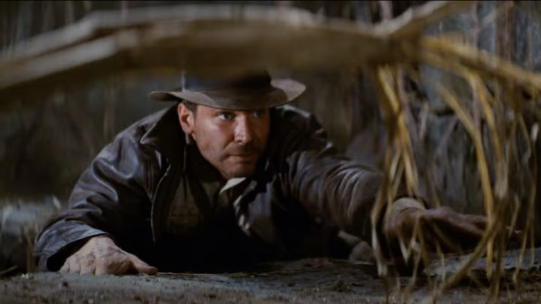 Indiana Jones reaches for a vine in Raiders of the Lost Ark