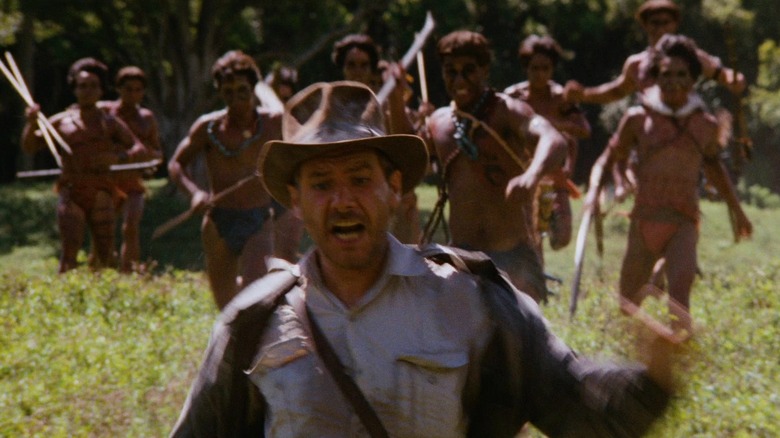 Harrison Ford as Indiana Jones running away from the local tribe in the opening of Raiders of the Lost Ark