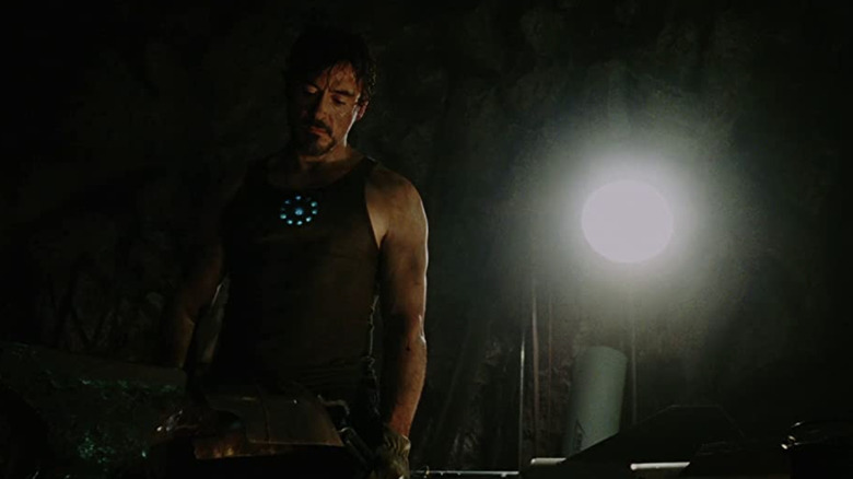 Tony Stark standing at his workbench