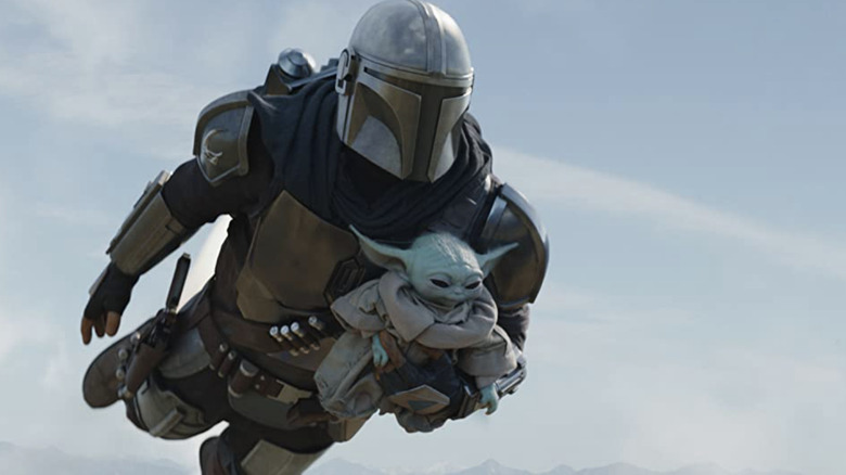 The Mandalorian flying away with the Child