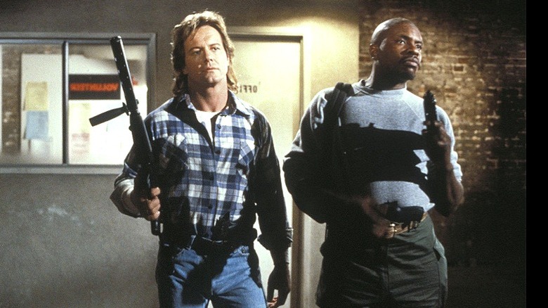 Nada and Frank with guns
