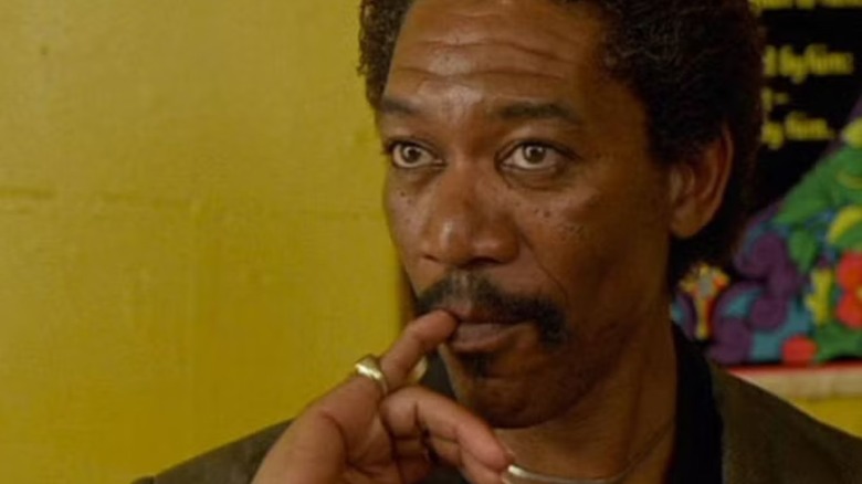 Morgan Freeman holding pinky to mouth