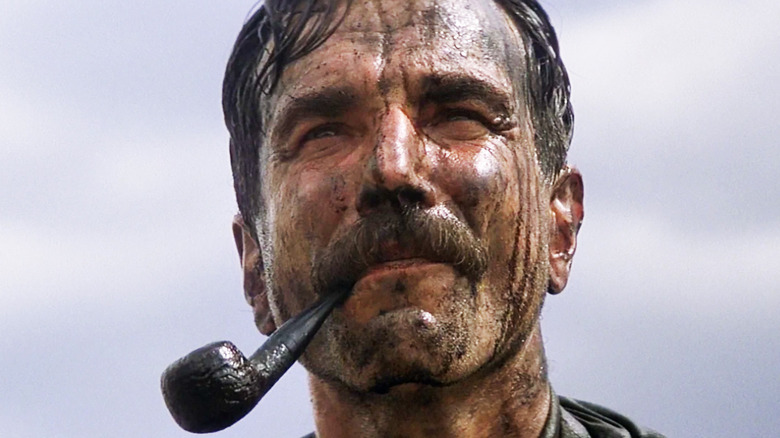 Daniel Plainview smokes a pipe