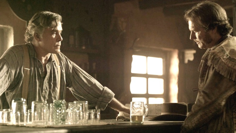 Ray Liotta's Lorca stands behind a bar opposite Bill Paxton's General Sam Houston in Texas Rising