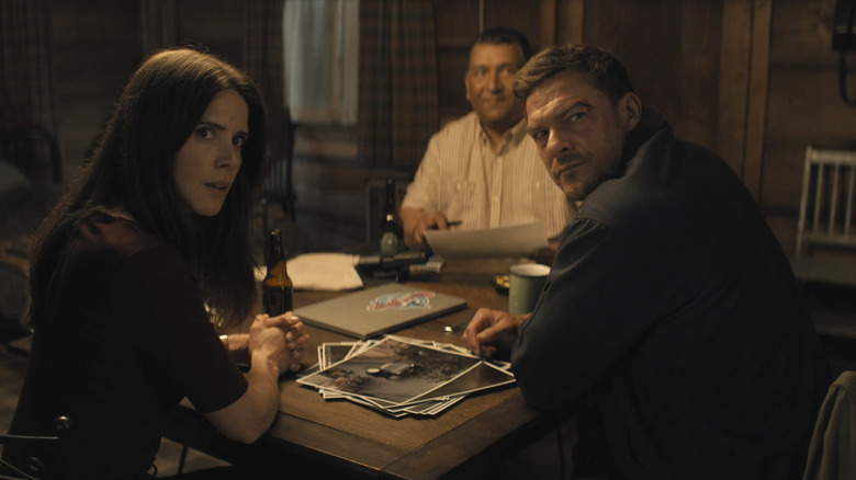 Reacher, Duffy, Guillermo and Reacher plotting at a motel table