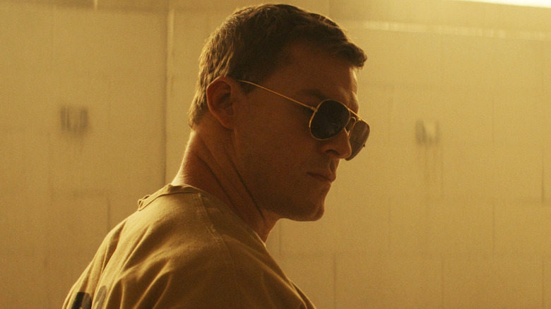Alan RItchson's Jack Reacher stand in a prison bathroom wearing shades in Reacher