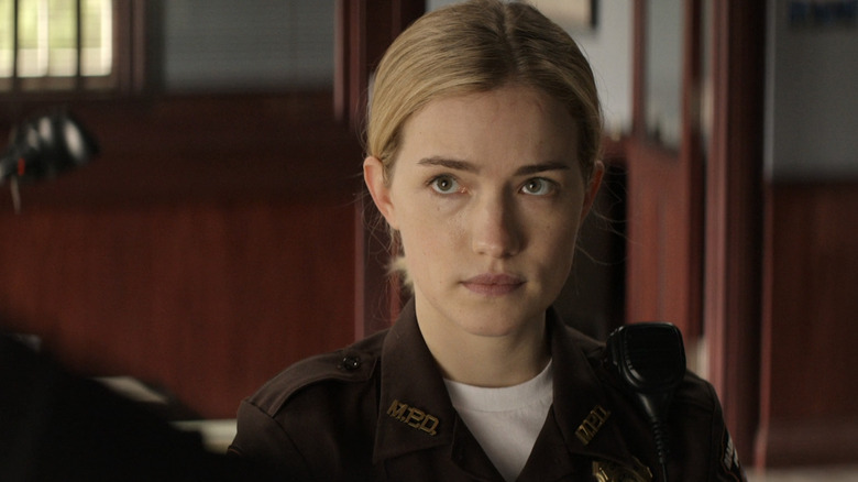 Willa Fitzgerald's Roscoe Conklin looks up at Reacher who stands offscreen in Reacher