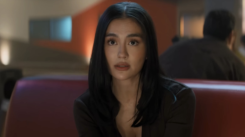 Agnez Mo's Lila Hoth sits in a bowling Alley in Reacher