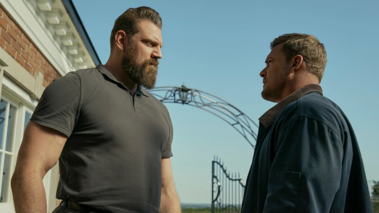 Reacher, Paulie and Reacher staring each other down