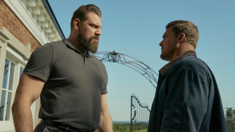 Olivier Ritchers' Paulie hulks over Alan Ritchson's Jack Reacher in Reacher