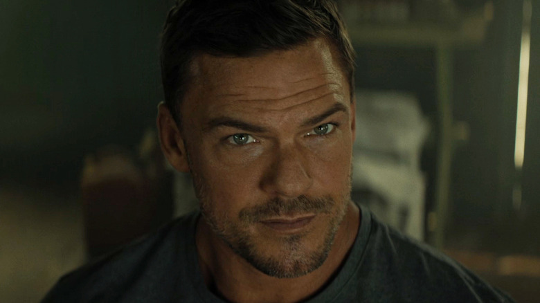 Alan Ritchson as Jack Reacher looks up in closeup in Reacher
