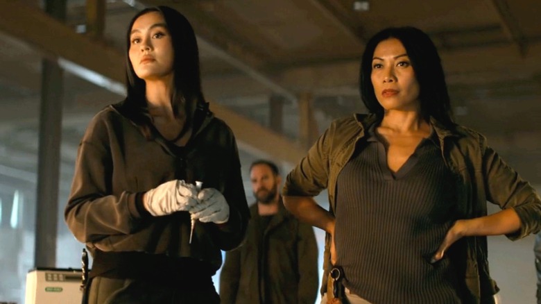 Agnez Mo's Lila Hoth and Anggun's Amisha Hoth stand side by side in a warehouse in Reacher