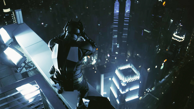 Christian Bale's Batman stands on top of a Hong Kong skyscraper looking down in The Dark Knight
