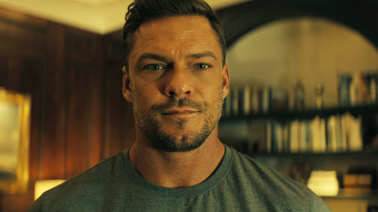 Alan RItchson's Jack Reacher is seen in closeup looking at the camera in Reacher