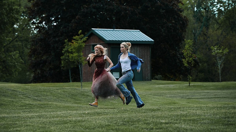 Grace and Faith running hand in hand through a field in Ready or Not 2: Here I Come