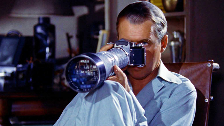 James Stewart using a camera to spy in Rear Window