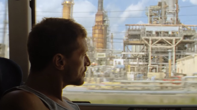 Simon Rex staring out a window in Red Rocket