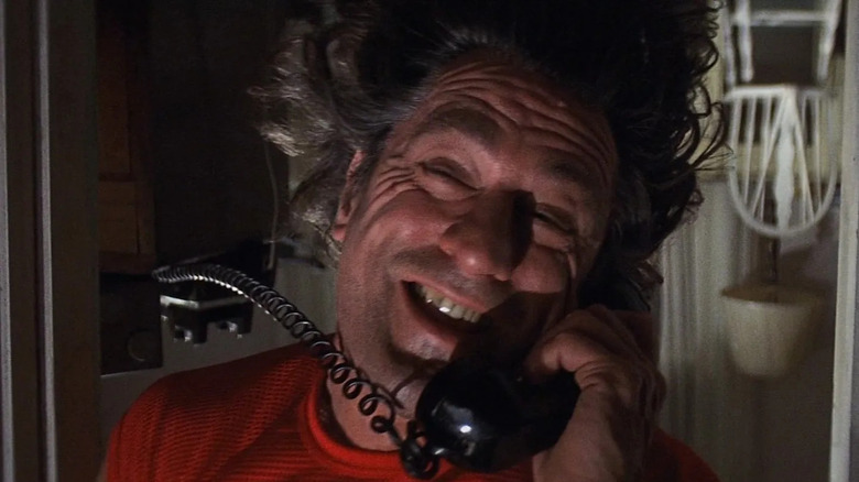 Robert De Niro in the role of Max Cady, hanging upside down while talking on the phone