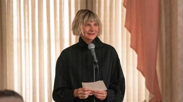 Kerri Kenny-Silver as Anne speaks into a microphone in The Four Seasons.