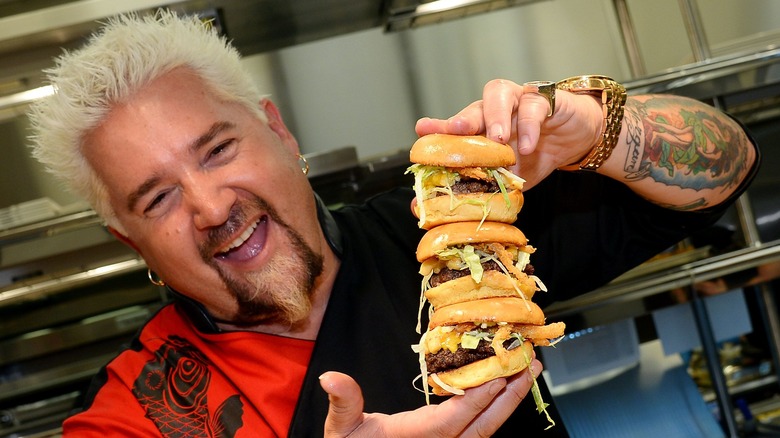 Guy Fieri with stacked cheeseburger sliders