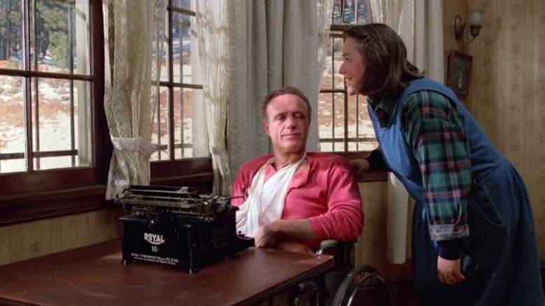 Paul Sheldon at typewriter with Annie Wilkes looking over him in Misery (1990)