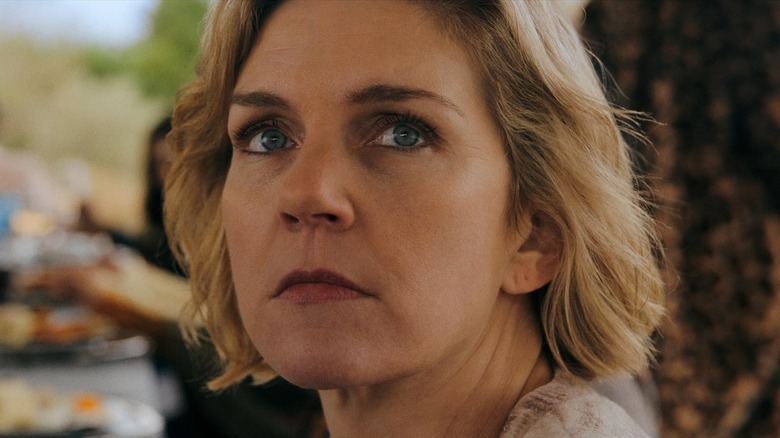 Rhea Seehorn as Carol Sturka looking upward in Pluribus