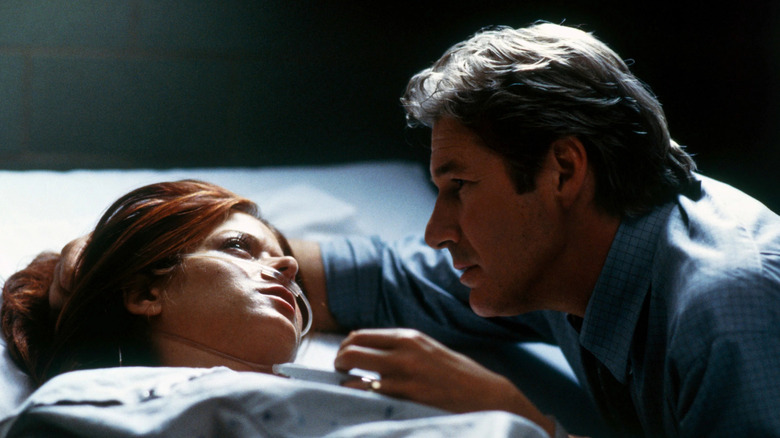 Mary dying in bed next to John in The Mothman Prophecies