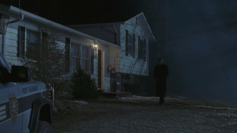A man standing in a dark West Virginian night in The Mothman Prophecies