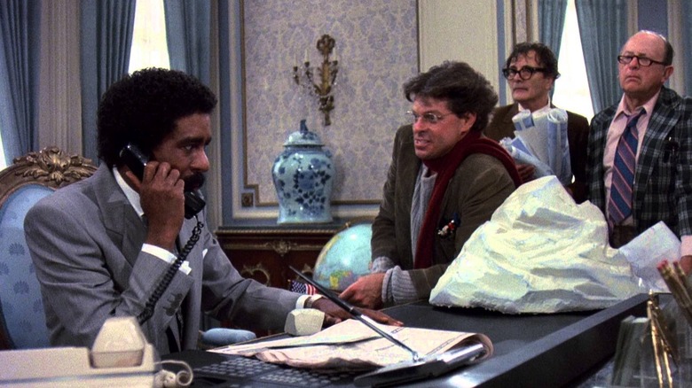 Brewster on the phone while angry investors look on in Brewster's Millions