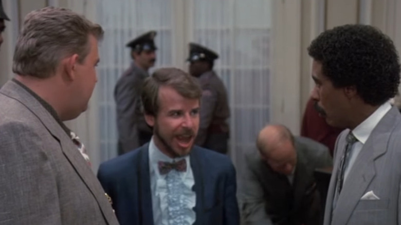 Spike and Brewster looking at Monty King, a professional mimic, in Brewster's Millions