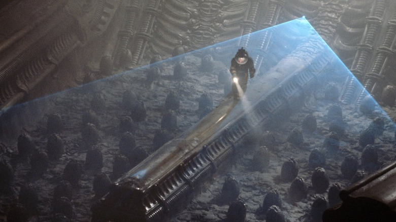 A Nostromo crewmember observes an alien nest of pods in Alien (1979)